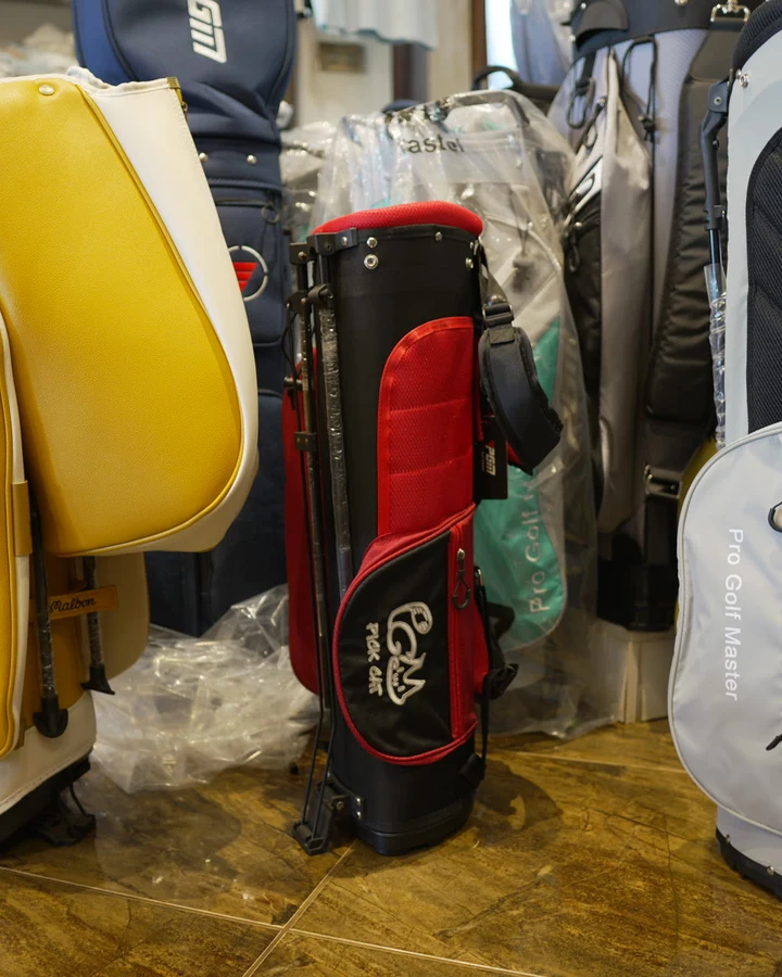 A yellow Malbon cart bag standing among other bags in the shop